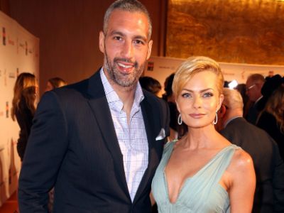 Hamzi Hijazi is wearing a suit whereas, Jaime Pressly is wearing a white dress.